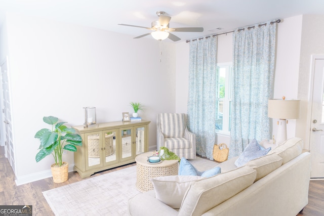 living room featuring ceiling fan and hardwood / wood-style floors