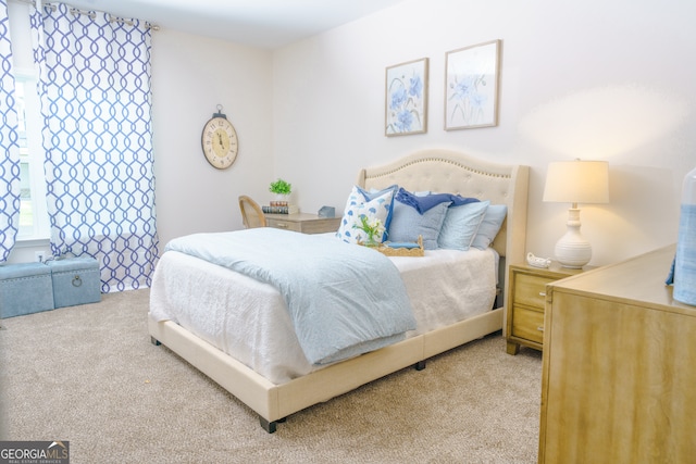 bedroom featuring light carpet