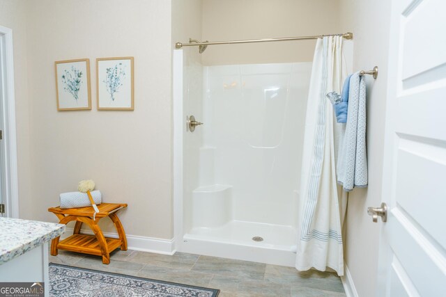 bathroom featuring vanity, tile patterned flooring, and a shower with curtain