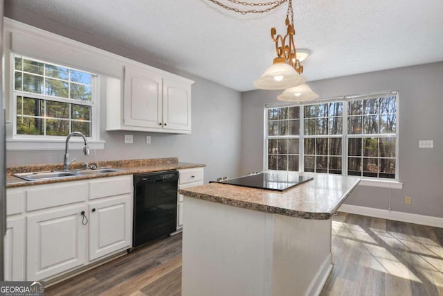 kitchen with a center island, wood-type flooring, hanging light fixtures, white cabinets, and black appliances