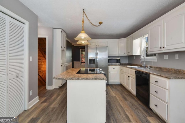 kitchen with sink, a kitchen island, black appliances, and dark hardwood / wood-style floors