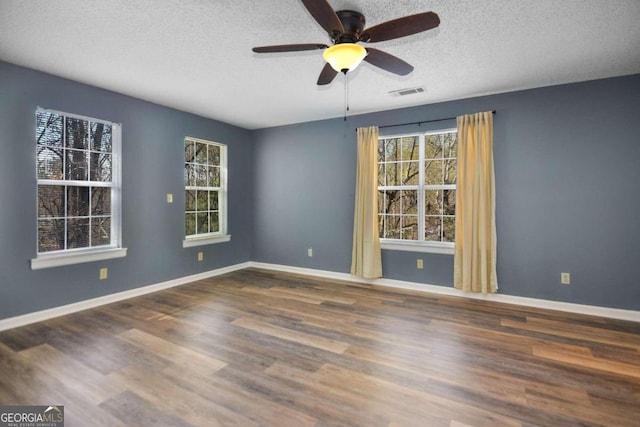 unfurnished room with dark hardwood / wood-style flooring, ceiling fan, and a textured ceiling