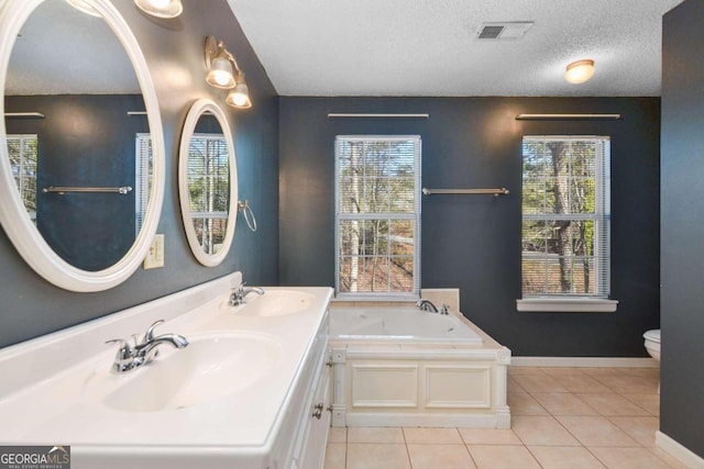 bathroom featuring a bath, vanity with extensive cabinet space, dual sinks, toilet, and tile floors