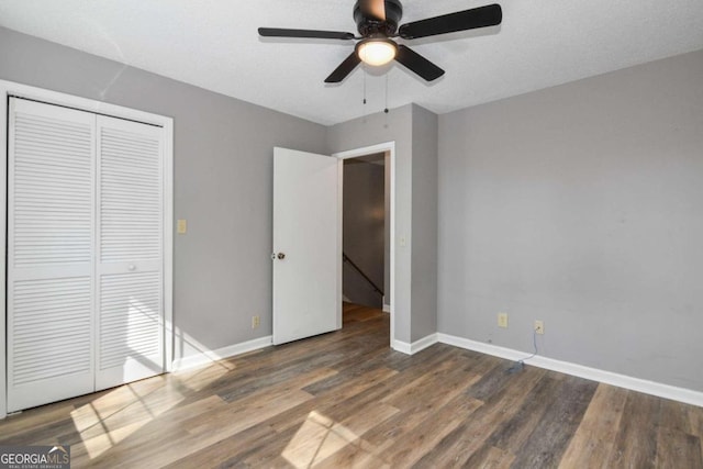 unfurnished bedroom with a closet, ceiling fan, and hardwood / wood-style flooring