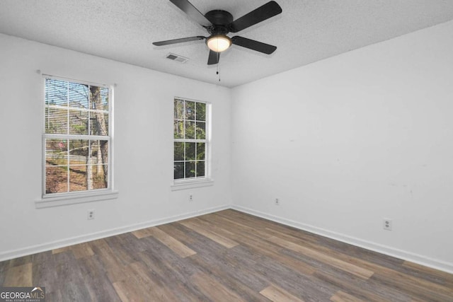 unfurnished room with dark hardwood / wood-style flooring, ceiling fan, and a textured ceiling