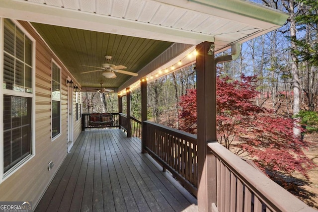 wooden deck featuring ceiling fan