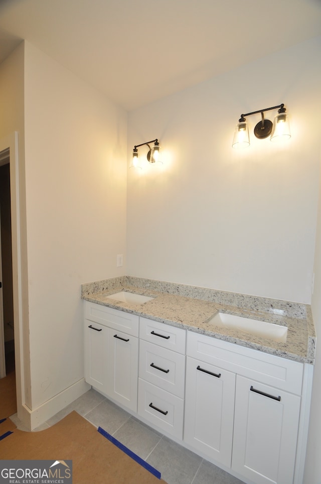 bathroom featuring dual bowl vanity and tile patterned flooring