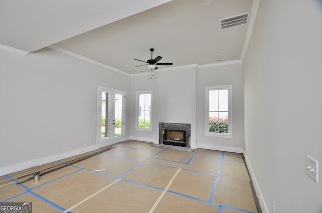 unfurnished living room featuring ceiling fan, crown molding, and a high end fireplace