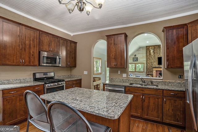 kitchen featuring a center island, sink, ornamental molding, dark hardwood / wood-style flooring, and stainless steel appliances