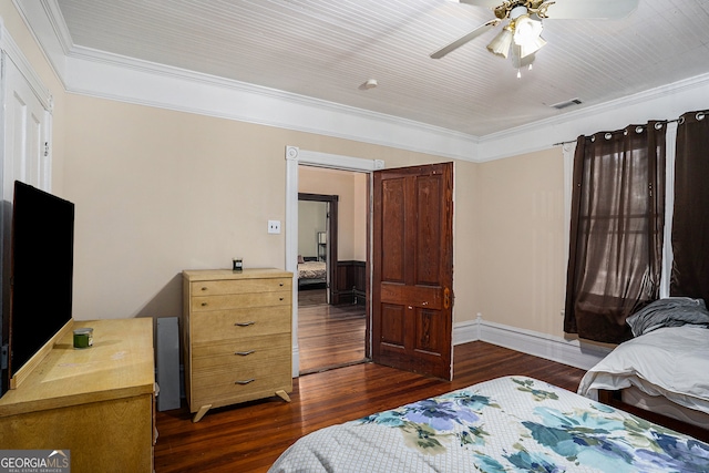 bedroom with crown molding, ceiling fan, and dark wood-type flooring