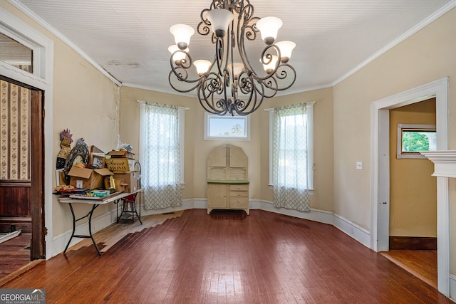 unfurnished dining area with hardwood / wood-style floors, a notable chandelier, and ornamental molding