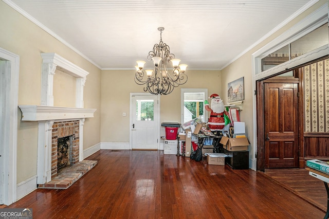 interior space featuring a fireplace, an inviting chandelier, dark wood-type flooring, and crown molding