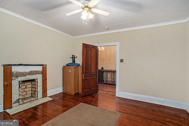 living room with ornamental molding, ceiling fan, and dark wood-type flooring