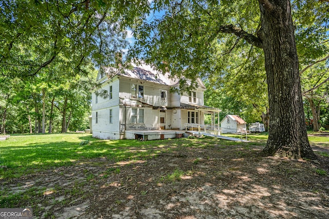 back of property featuring a yard