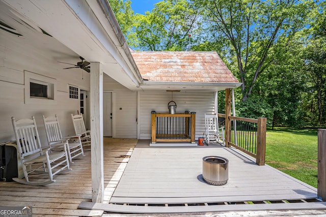 wooden terrace with a yard and ceiling fan