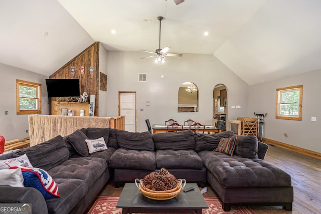 living room with ceiling fan, dark hardwood / wood-style flooring, and lofted ceiling