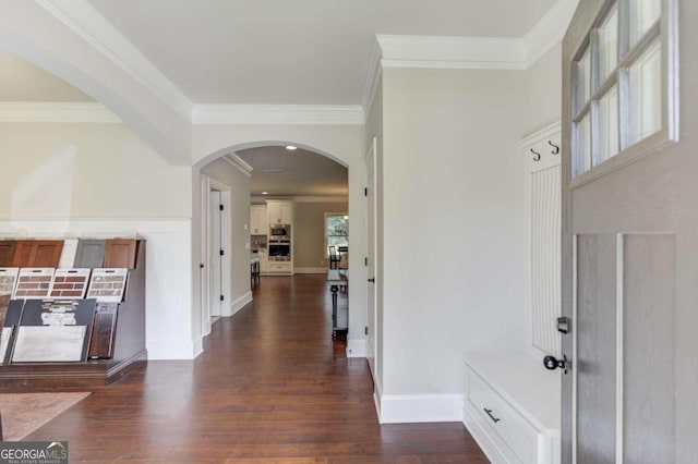 entrance foyer featuring crown molding and dark wood-type flooring