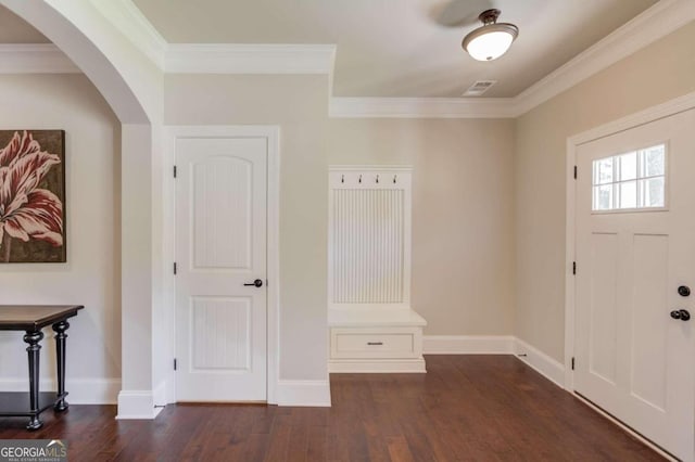 foyer with dark wood-type flooring and crown molding