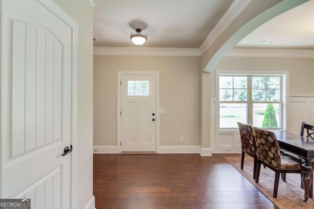 entryway with dark hardwood / wood-style floors and crown molding