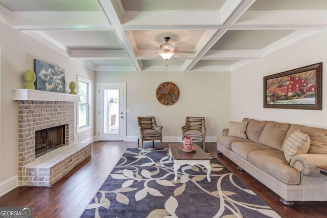 living room with ceiling fan, dark hardwood / wood-style floors, coffered ceiling, beam ceiling, and a fireplace