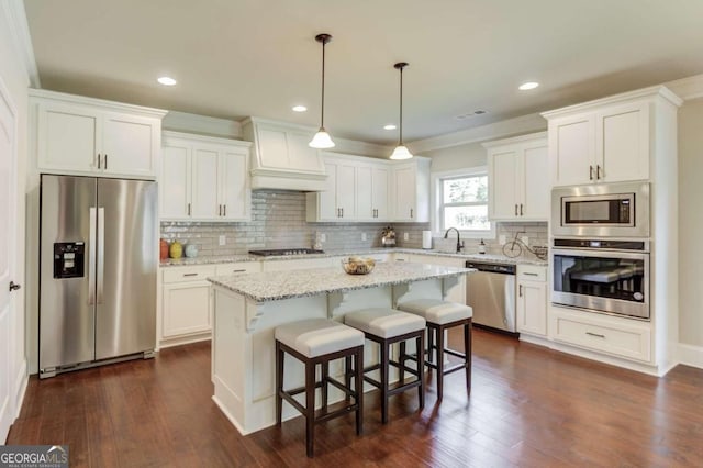 kitchen featuring tasteful backsplash, appliances with stainless steel finishes, dark hardwood / wood-style floors, and premium range hood