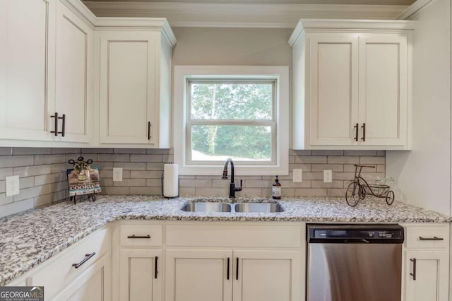 kitchen featuring decorative backsplash, stainless steel dishwasher, white cabinetry, light stone counters, and sink