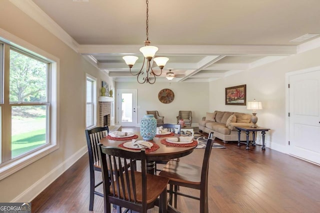 dining room with dark wood-type flooring, plenty of natural light, and an inviting chandelier