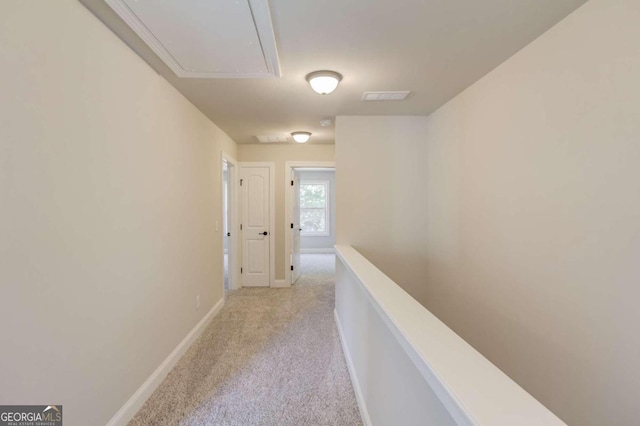 hall with light colored carpet