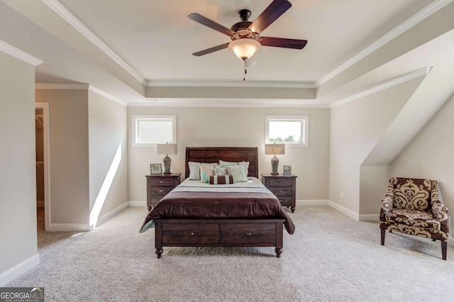 bedroom with ceiling fan, a raised ceiling, ornamental molding, and light colored carpet