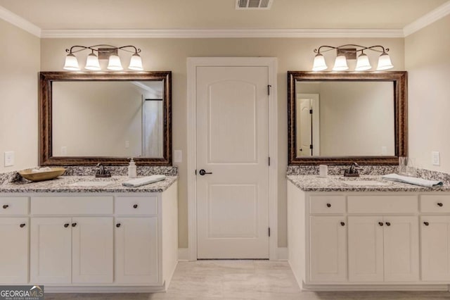 bathroom featuring ornamental molding and vanity