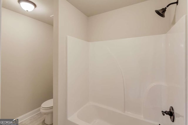 bathroom with toilet and washtub / shower combination