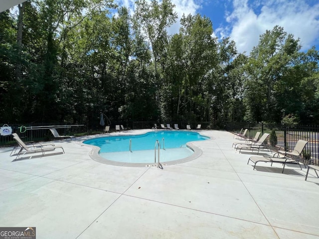 view of swimming pool with a patio area