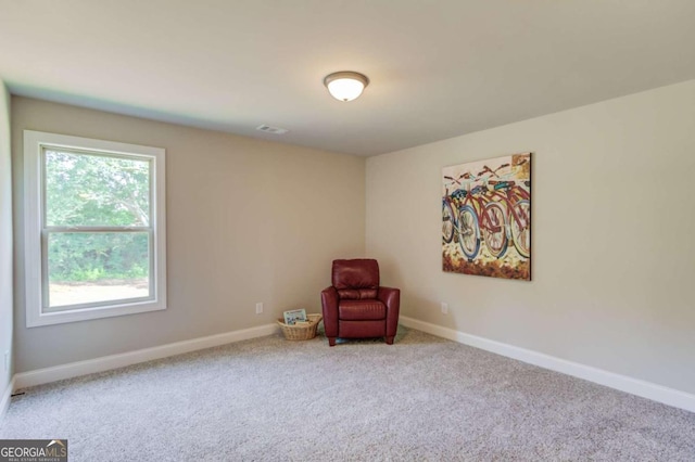 unfurnished room featuring a wealth of natural light and carpet flooring