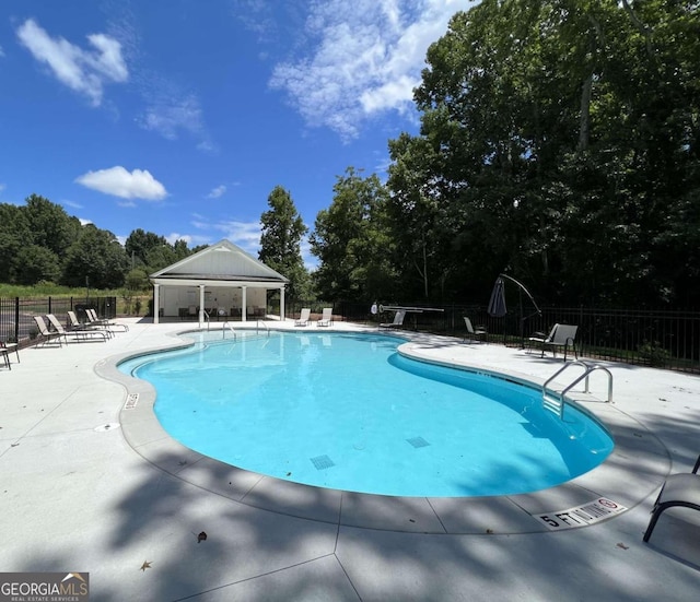 view of swimming pool with a patio and a gazebo