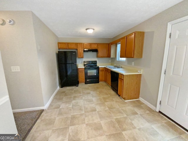 kitchen featuring sink, light tile floors, and black appliances