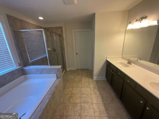 bathroom featuring tile patterned flooring, shower with separate bathtub, and vanity