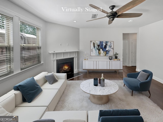 living room with hardwood / wood-style floors and ceiling fan