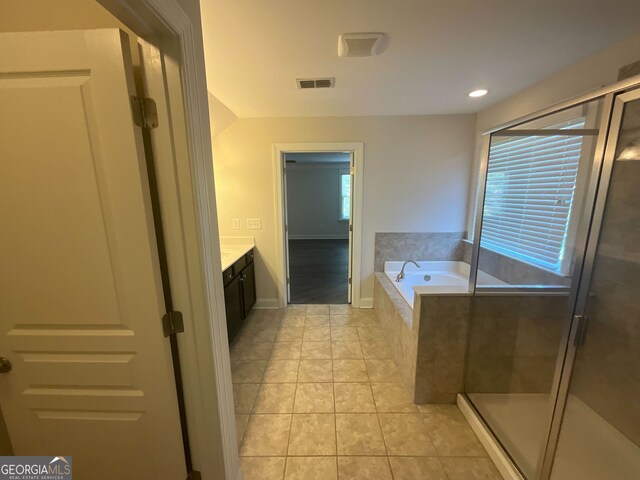 bathroom featuring tile patterned floors, plenty of natural light, vanity, and independent shower and bath