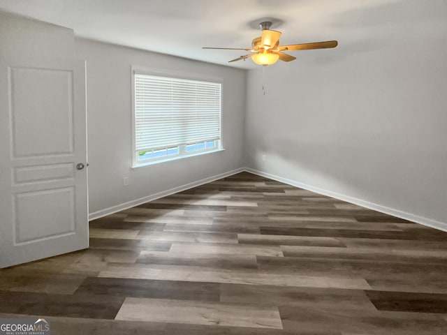 unfurnished room with ceiling fan and dark hardwood / wood-style flooring