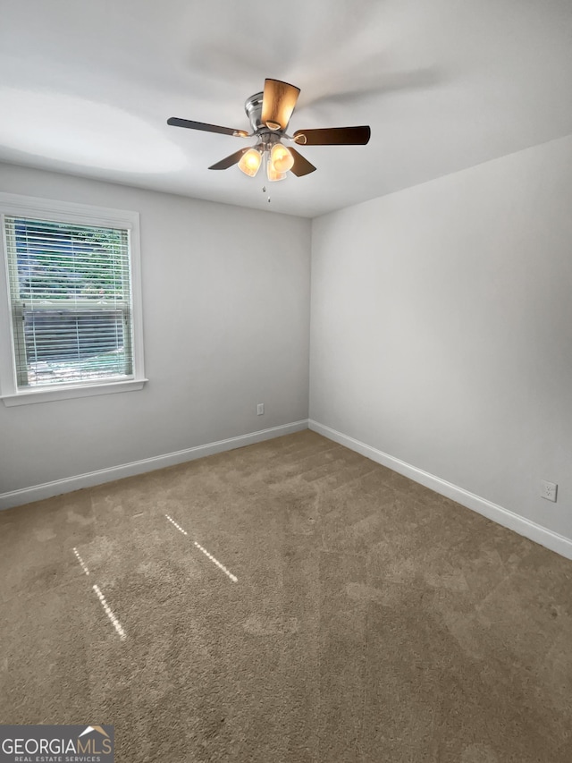 empty room with carpet floors and ceiling fan