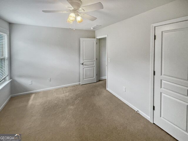 unfurnished bedroom featuring ceiling fan and carpet floors