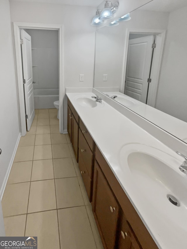 bathroom featuring tile patterned floors, vanity, and toilet