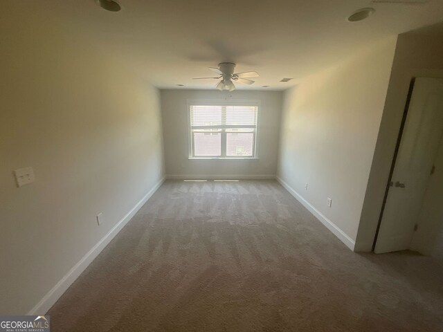 empty room with light carpet and ceiling fan