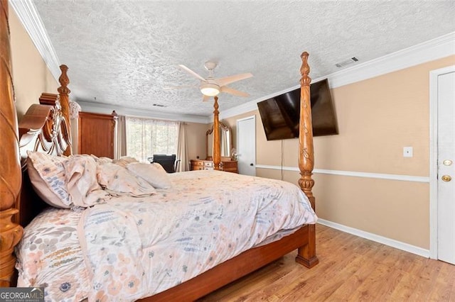 bedroom featuring hardwood / wood-style floors, ceiling fan, crown molding, and a textured ceiling