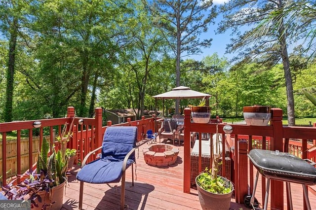 wooden terrace with a fire pit