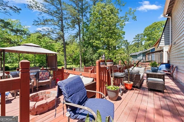 wooden terrace with a fire pit and a gazebo