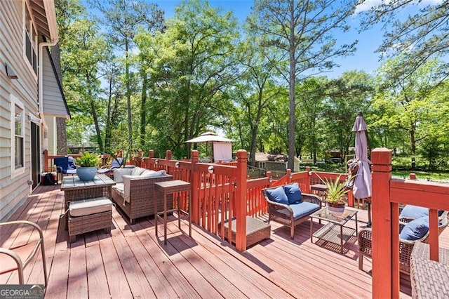 wooden terrace with an outdoor living space