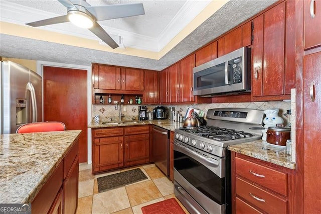 kitchen with backsplash, ceiling fan, stainless steel appliances, sink, and ornamental molding