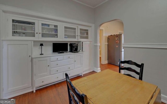 dining room featuring hardwood / wood-style floors and ornamental molding