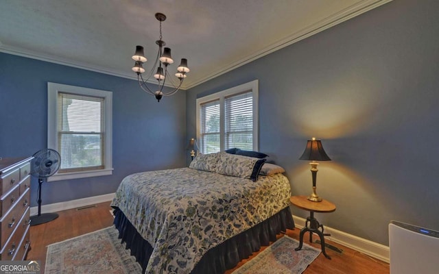 bedroom with wood-type flooring, crown molding, and a chandelier